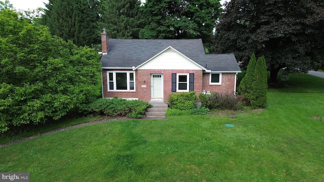 4599 Carlisle Rd, Gardners, PA 17324 - view of front of house with a front yard, a chimney, and brick siding