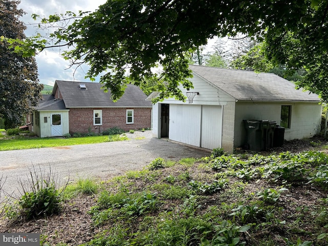 4599 Carlisle Rd, Gardners, PA 17324 - rear view of house with an outbuilding, asphalt driveway, and a shingled roof