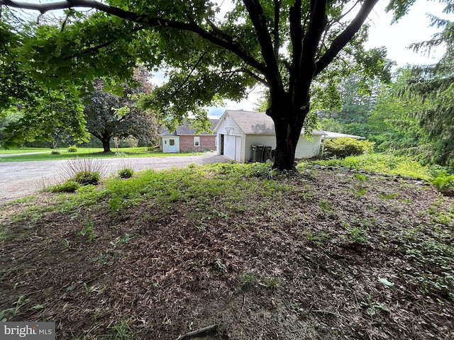 4599 Carlisle Rd, Gardners, PA 17324 - view of yard featuring an outdoor structure, asphalt driveway, and a garage