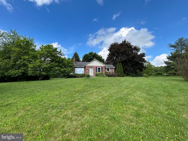 4599 Carlisle Rd, Gardners, PA 17324 - view of front facade with a front yard, a chimney, and brick siding