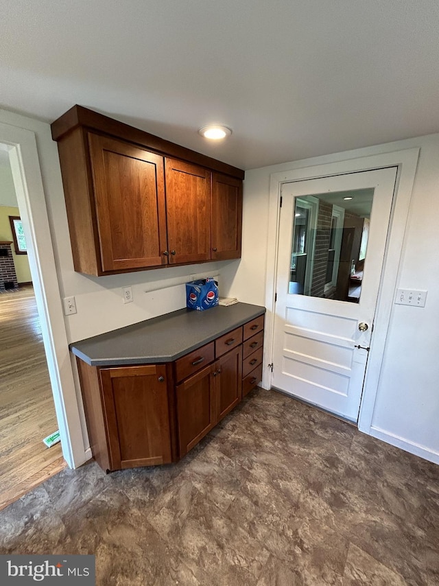 4599 Carlisle Rd, Gardners, PA 17324 - kitchen with dark countertops, brown cabinetry, and dark flooring