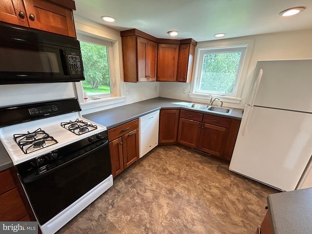 4599 Carlisle Rd, Gardners, PA 17324 - kitchen with white appliances, a sink, brown cabinets, dark countertops, and recessed lighting