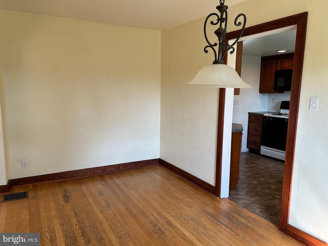 4599 Carlisle Rd, Gardners, PA 17324 - unfurnished dining area with baseboards and dark wood-style flooring