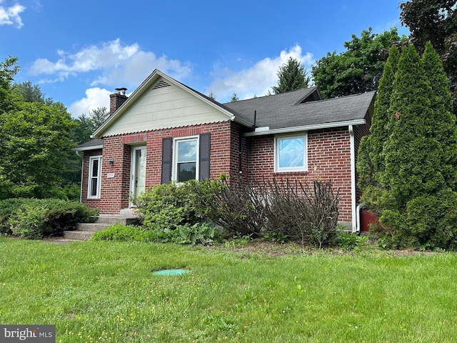 4599 Carlisle Rd, Gardners, PA 17324 - view of front of house featuring a chimney, brick siding, a front lawn, and roof with shingles