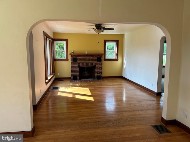 4599 Carlisle Rd, Gardners, PA 17324 - unfurnished living room with ceiling fan, wood finished floors, arched walkways, a fireplace, and baseboards