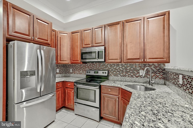 1129 Washington Blvd, Baltimore, MD 21230 - kitchen with appliances with stainless steel finishes, a sink, light stone counters, light tile patterned floors, and decorative backsplash