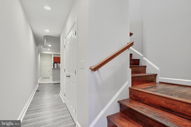 1129 Washington Blvd, Baltimore, MD 21230 - staircase featuring recessed lighting, wood finished floors, and baseboards