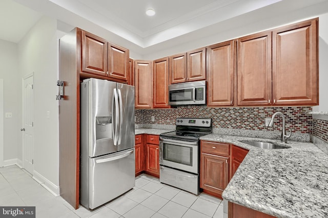 1129 Washington Blvd, Baltimore, MD 21230 - kitchen with appliances with stainless steel finishes, a sink, light tile patterned flooring, light stone counters, and tasteful backsplash