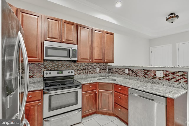 1129 Washington Blvd, Baltimore, MD 21230 - kitchen featuring stainless steel appliances, a sink, decorative backsplash, a peninsula, and light tile patterned floors
