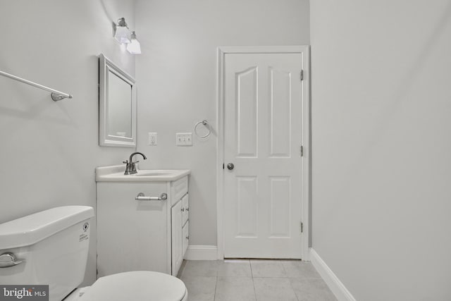 1129 Washington Blvd, Baltimore, MD 21230 - bathroom with tile patterned floors, toilet, vanity, and baseboards