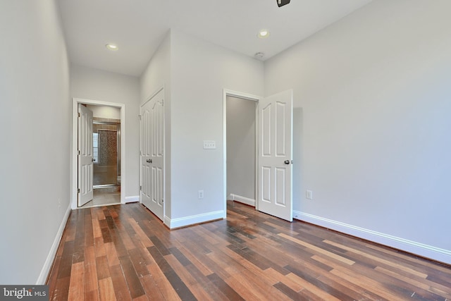 1129 Washington Blvd, Baltimore, MD 21230 - unfurnished bedroom featuring wood finished floors, baseboards, ensuite bath, and recessed lighting