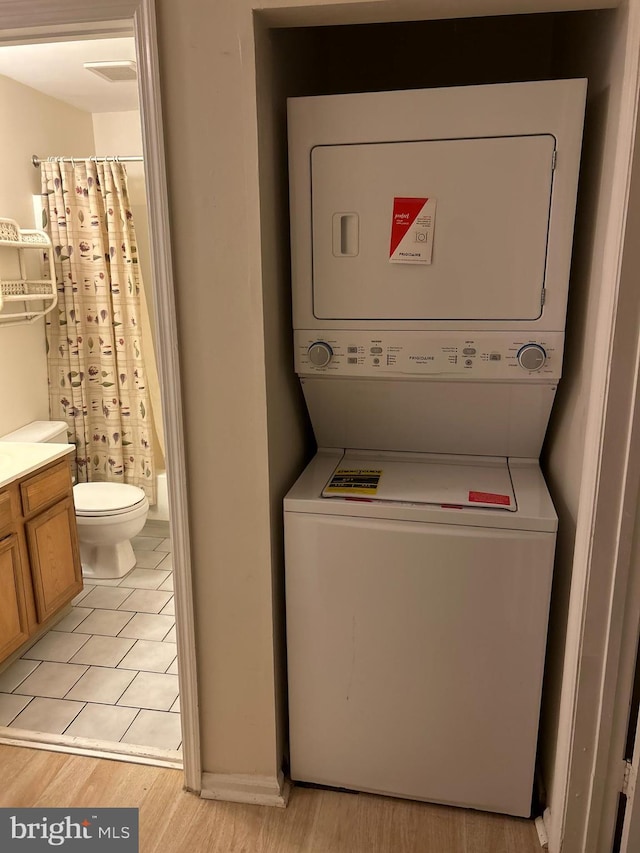 102 Stone Hurst Ct Unit 102, New Castle, DE 19720 - laundry room with stacked washer and clothes dryer and light wood-style floors