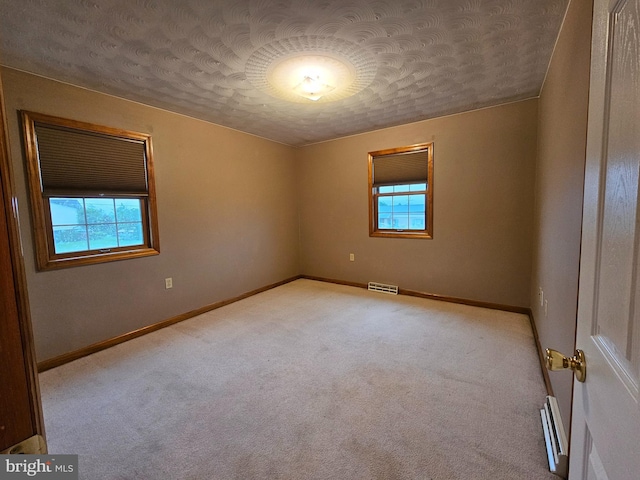 1511 Saint Francis Ln, Altoona, PA 16602 - unfurnished room featuring a textured ceiling, carpet flooring, baseboards, and a baseboard radiator