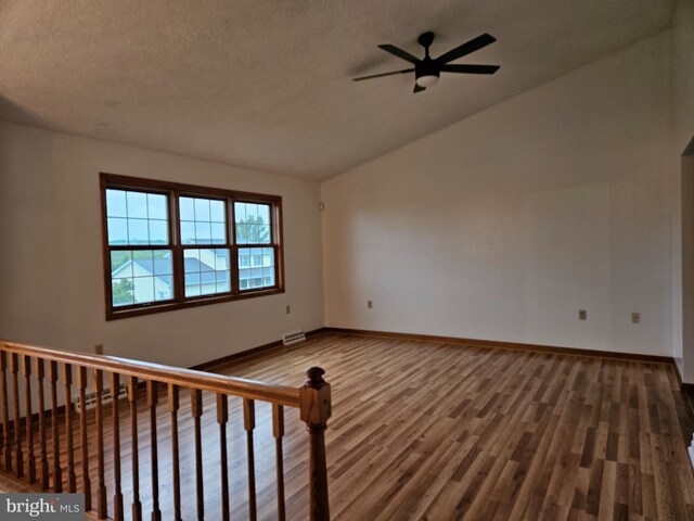 1511 Saint Francis Ln, Altoona, PA 16602 - spare room with vaulted ceiling, a ceiling fan, wood finished floors, baseboards, and a textured ceiling