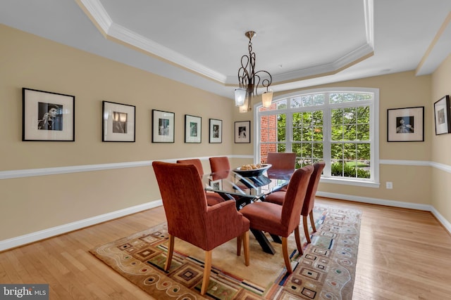 8220 Waterside Ct, Fort Washington, MD 20744 - dining area featuring a raised ceiling, crown molding, light wood-style floors, a chandelier, and baseboards