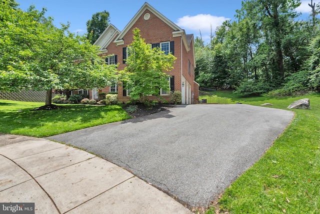 8220 Waterside Ct, Fort Washington, MD 20744 - view of front of house featuring brick siding, a front yard, and driveway