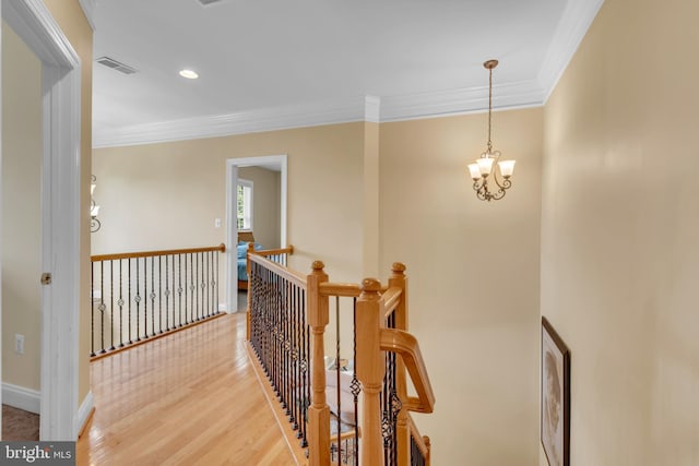 8220 Waterside Ct, Fort Washington, MD 20744 - hallway with an upstairs landing, ornamental molding, a chandelier, light wood-style flooring, and baseboards