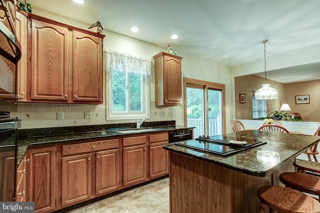 235 Amherst Dr, Doylestown, PA 18901 - kitchen with a kitchen bar, a sink, a center island, backsplash, and hanging light fixtures