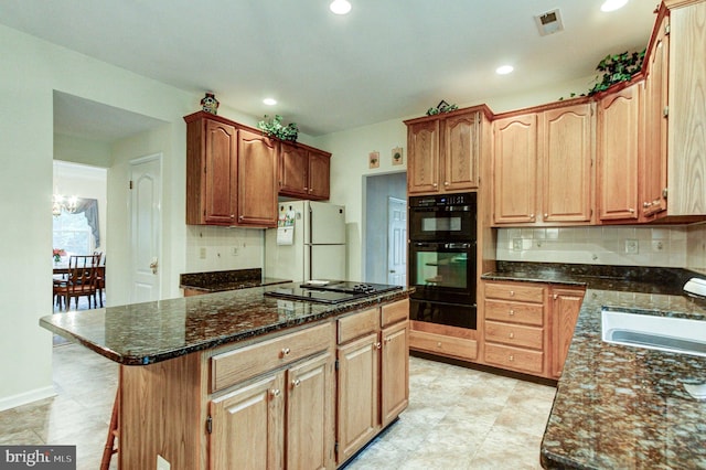 235 Amherst Dr, Doylestown, PA 18901 - kitchen featuring black appliances, a sink, a warming drawer, decorative backsplash, and dark stone countertops