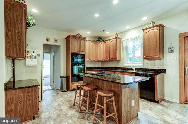 235 Amherst Dr, Doylestown, PA 18901 - kitchen featuring black appliances, a kitchen breakfast bar, dark stone counters, recessed lighting, and a kitchen island