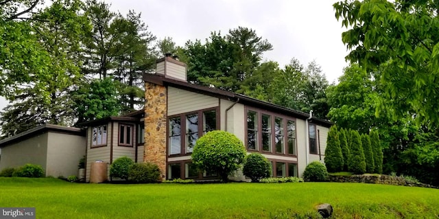 1272 Penfield Rd, State College, PA 16801 - rear view of house featuring a chimney, a yard, and stucco siding