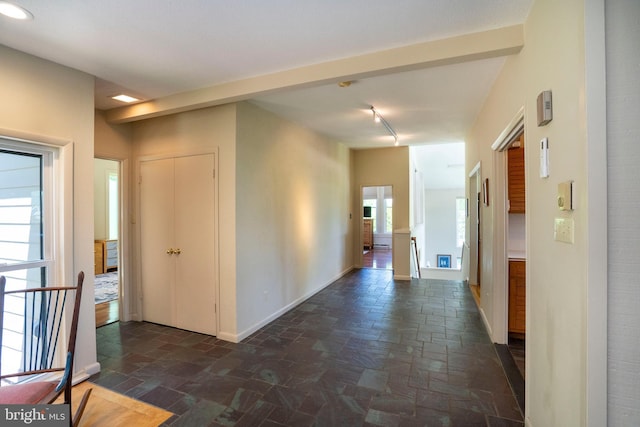 1272 Penfield Rd, State College, PA 16801 - hallway featuring dark stone finish floors, baseboards, and track lighting