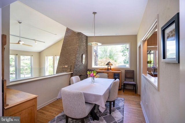 1272 Penfield Rd, State College, PA 16801 - dining room with hardwood / wood-style flooring, vaulted ceiling, baseboards, and track lighting