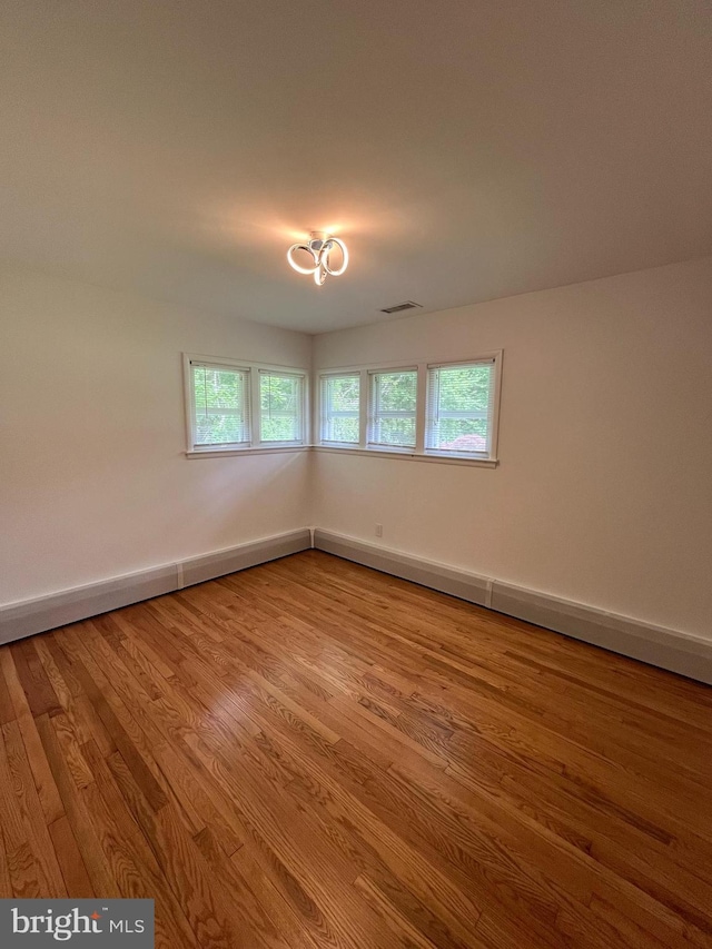 905 Dunellen Dr, Towson, MD 21286 - spare room with wood finished floors, plenty of natural light, and baseboards