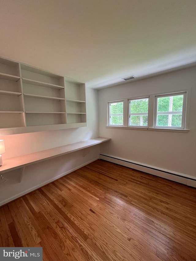 905 Dunellen Dr, Towson, MD 21286 - unfurnished office featuring a baseboard heating unit and wood finished floors