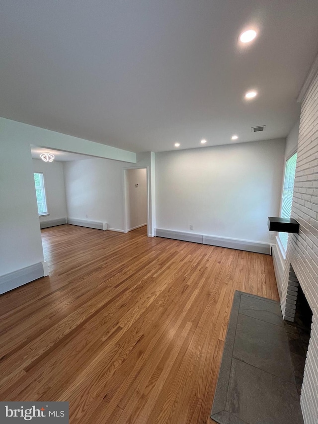 905 Dunellen Dr, Towson, MD 21286 - unfurnished living room with a brick fireplace, wood finished floors, baseboards, and recessed lighting