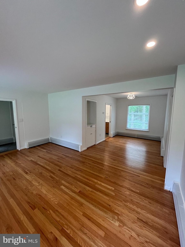 905 Dunellen Dr, Towson, MD 21286 - unfurnished living room featuring wood finished floors, baseboards, baseboard heating, and recessed lighting