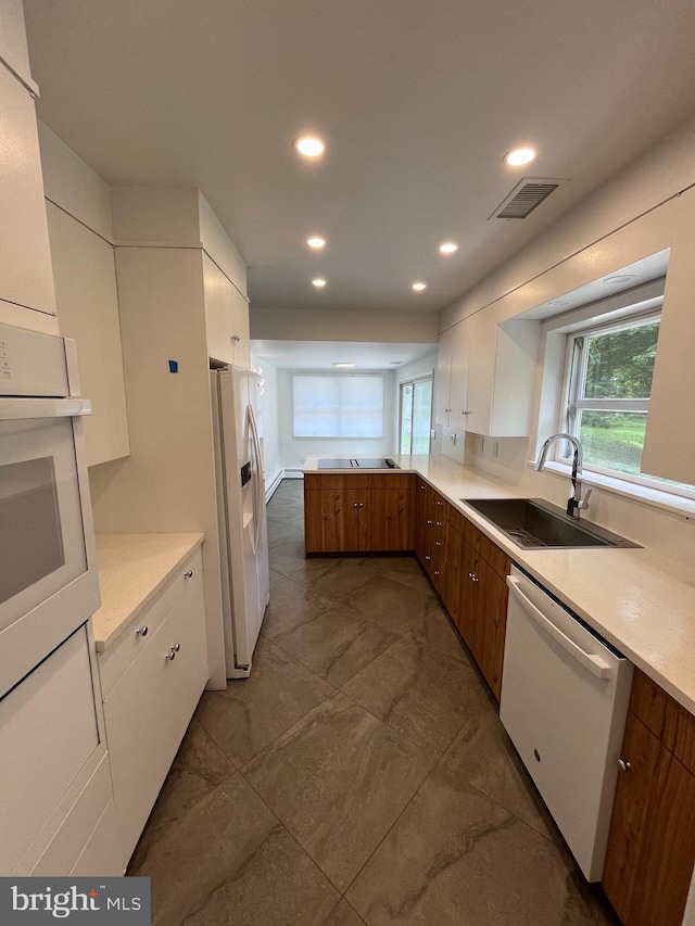 905 Dunellen Dr, Towson, MD 21286 - kitchen with white appliances, a sink, light countertops, white cabinetry, and recessed lighting