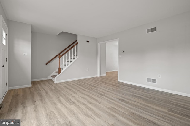 6127 Haymarket Way, Mechanicsburg, PA 17050 - unfurnished living room with light wood-type flooring, stairway, and baseboards