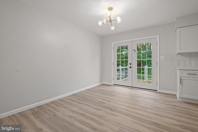 6127 Haymarket Way, Mechanicsburg, PA 17050 - unfurnished dining area featuring french doors, a chandelier, light wood-style flooring, and baseboards