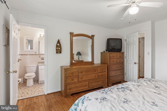1316 Carpenters Point Rd, Perryville, MD 21903 - bedroom featuring wood finished floors, tile walls, connected bathroom, and a ceiling fan
