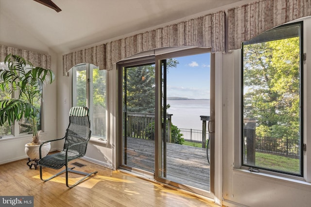 1316 Carpenters Point Rd, Perryville, MD 21903 - living area with a water view, wood finished floors, lofted ceiling, and baseboards
