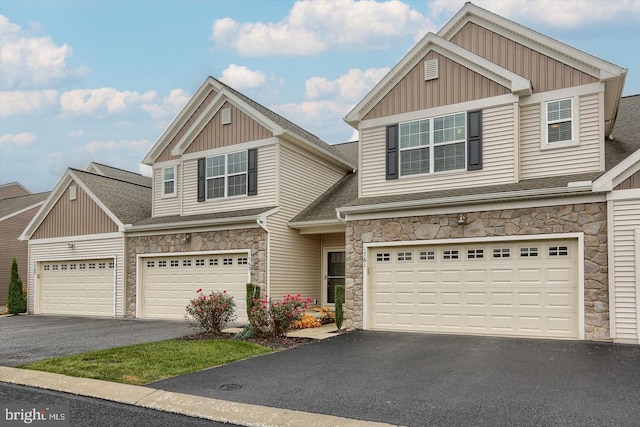 1761 Shady Ln, Mechanicsburg, PA 17055 - view of front of property with driveway, stone siding, board and batten siding, a garage, and a shingled roof