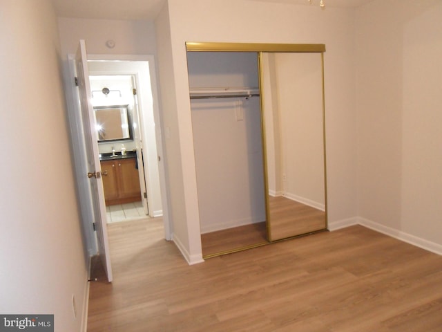 6087 Majors Ln Unit 1, Columbia, MD 21045 - unfurnished bedroom with light wood finished floors, a closet, and baseboards