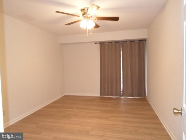 6087 Majors Ln Unit 1, Columbia, MD 21045 - empty room with a ceiling fan, light wood-style flooring, and baseboards