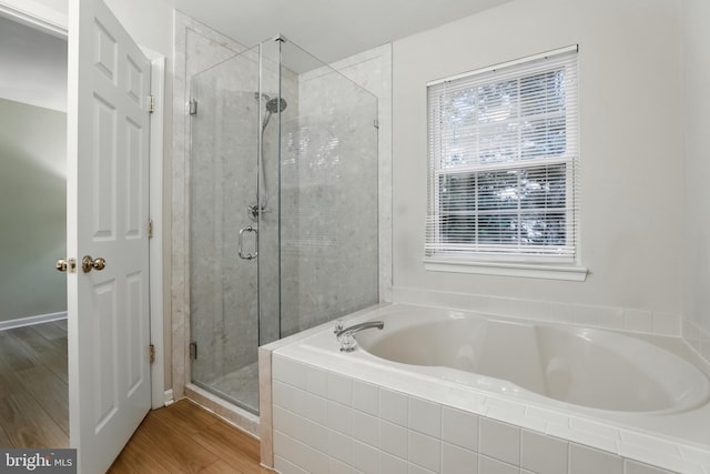 11438 Abner Ave, Fairfax, VA 22030 - full bath featuring a bath, a stall shower, plenty of natural light, and wood finished floors