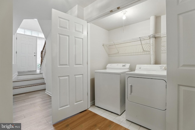11438 Abner Ave, Fairfax, VA 22030 - washroom with washer and clothes dryer, light wood finished floors, and healthy amount of natural light