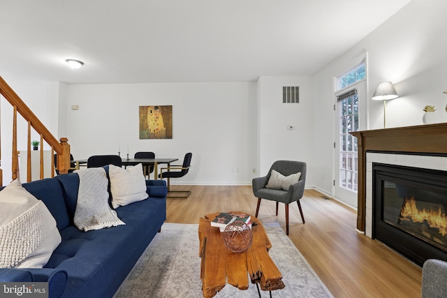 11438 Abner Ave, Fairfax, VA 22030 - living room with light wood-type flooring, stairway, a tile fireplace, and baseboards