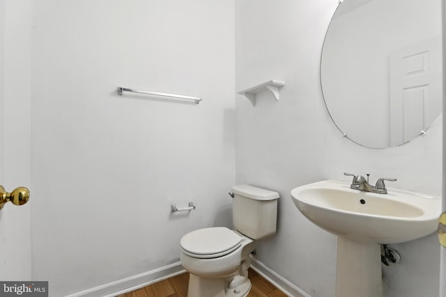 11438 Abner Ave, Fairfax, VA 22030 - bathroom featuring wood finished floors, baseboards, toilet, and a sink