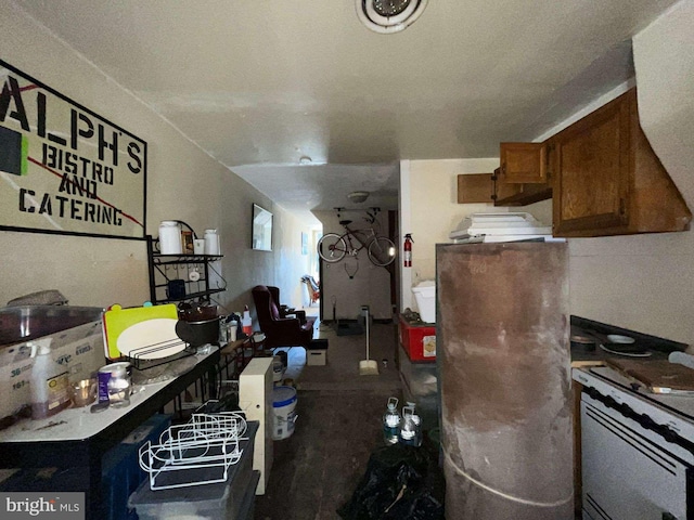 1744 Llewelyn Ave, Baltimore, MD 21213 - kitchen with freestanding refrigerator, brown cabinetry, and white range