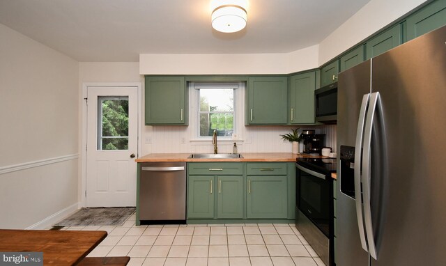 16 Grove Cir, Sellersville, PA 18960 - kitchen featuring appliances with stainless steel finishes, green cabinetry, a sink, butcher block countertops, and plenty of natural light