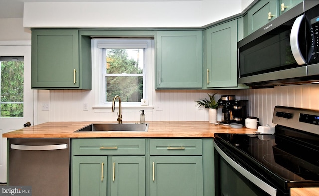 16 Grove Cir, Sellersville, PA 18960 - kitchen featuring appliances with stainless steel finishes, green cabinets, a sink, and butcher block counters