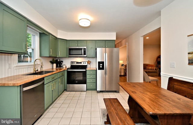 16 Grove Cir, Sellersville, PA 18960 - kitchen with stainless steel appliances, green cabinets, a sink, and light tile patterned flooring