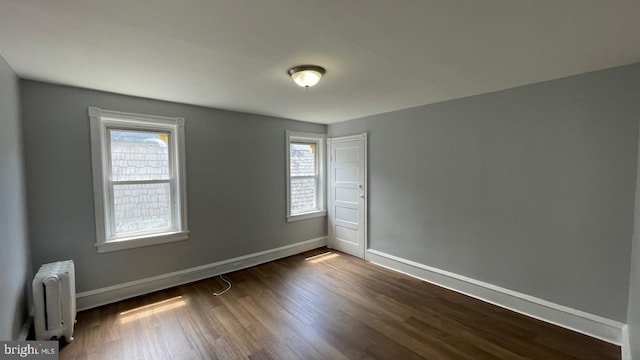 4937 N 13th St, Philadelphia, PA 19141 - empty room with radiator, plenty of natural light, dark wood finished floors, and baseboards
