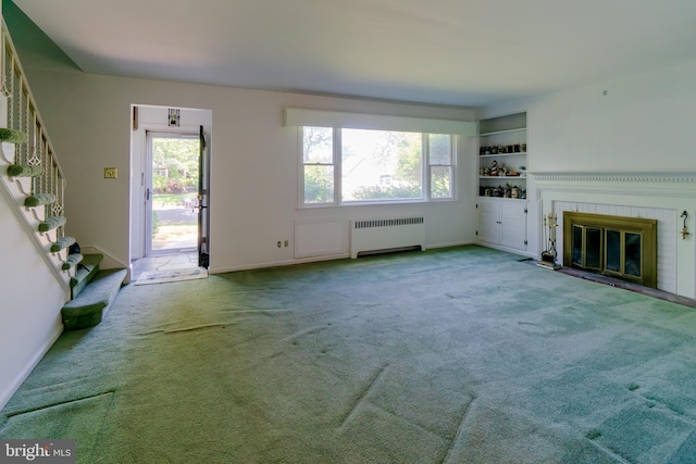 209 Berkshire Ave, Linwood, NJ 08221 - unfurnished living room featuring radiator, carpet flooring, a brick fireplace, stairs, and baseboards
