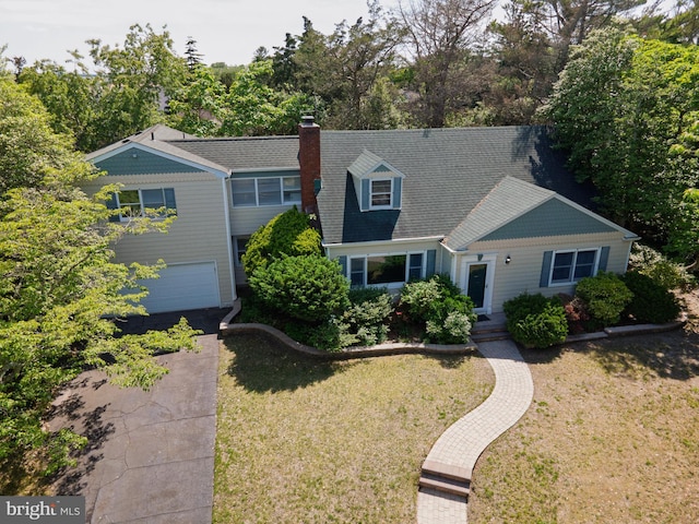 209 Berkshire Ave, Linwood, NJ 08221 - view of front facade featuring a front lawn, a chimney, view of wooded area, and an attached garage